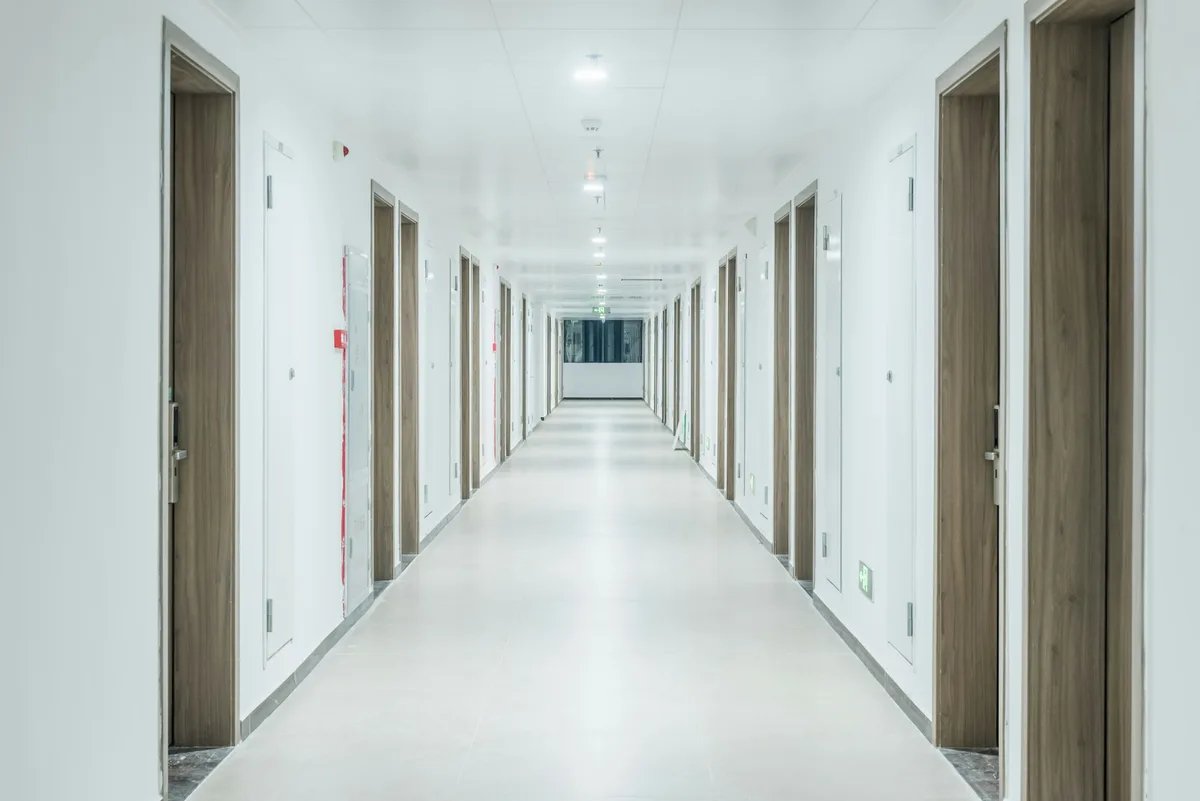 A long corridor with doors on both sides.